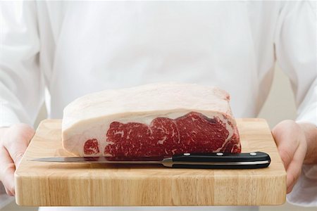 rumpsteak - A piece of beef sirloin on wooden board Stock Photo - Premium Royalty-Free, Code: 659-01854974