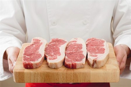 rumpsteak - Sirloin steaks on wooden board Stock Photo - Premium Royalty-Free, Code: 659-01854975