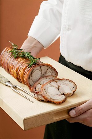 Boned and rolled saddle of suckling pig on a wooden board Stock Photo - Premium Royalty-Free, Code: 659-01855015