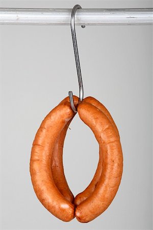 Four red bratwurst on a hook Stock Photo - Premium Royalty-Free, Code: 659-01855192