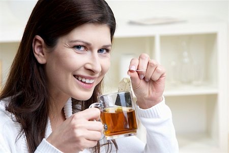 Woman holding cup of tea and tea bag in her hands Stock Photo - Premium Royalty-Free, Code: 659-01855223