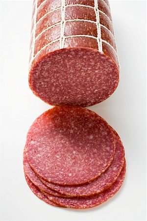 raw sausage - Salami, a piece and slices Stock Photo - Premium Royalty-Free, Code: 659-01855328