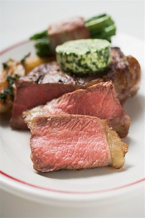 simsearch:659-06903102,k - Beef steak with herb butter and bacon-wrapped beans Stock Photo - Premium Royalty-Free, Code: 659-01855320