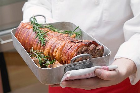 Rolled saddle of suckling pig in roasting tin with rosemary Stock Photo - Premium Royalty-Free, Code: 659-01855386