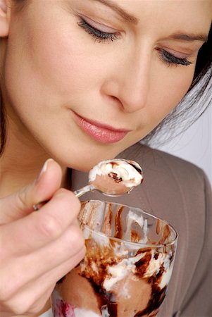 Woman eating chocolate ice cream sundae Stock Photo - Premium Royalty-Free, Code: 659-01855450