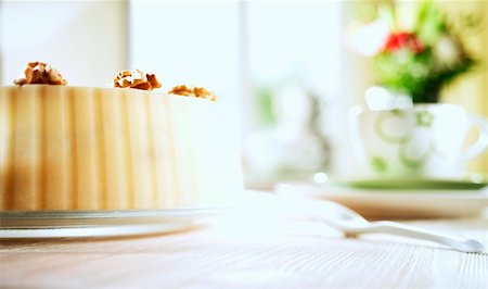 Walnut cake on table laid for coffee Stock Photo - Premium Royalty-Free, Code: 659-01855497