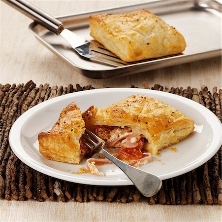 puff pastry turnover - Puff pastry pasties with ham and tomato filling Stock Photo - Premium Royalty-Free, Code: 659-01855619