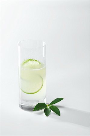 Gin Fizz in tall glass with slices of lime Stock Photo - Premium Royalty-Free, Code: 659-01855699