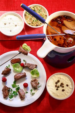 Meat fondue with broth and a selection of dips Stock Photo - Premium Royalty-Free, Code: 659-01855711