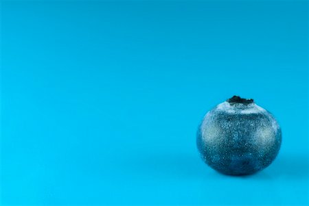 A blueberry against a blue background Stock Photo - Premium Royalty-Free, Code: 659-01855735