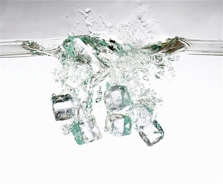 Several ice cubes falling into water Stock Photo - Premium Royalty-Free, Code: 659-01855782