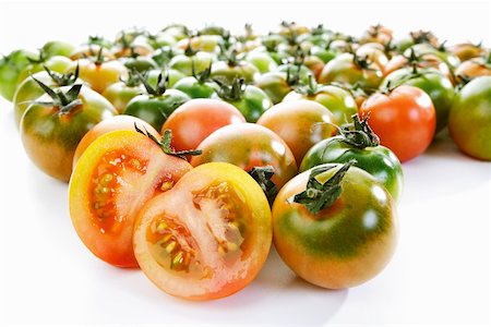 Unripe tomatoes, one halved Stock Photo - Premium Royalty-Free, Code: 659-01855806