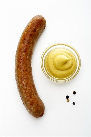 salsichão de porco - A sausage with mustard Foto de stock - Royalty Free Premium, Número: 659-01855890