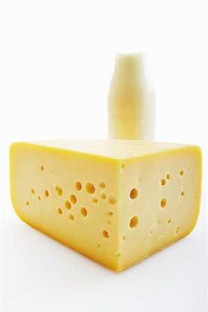 simsearch:659-01854208,k - A piece of cheese with a bottle of milk in the background Stock Photo - Premium Royalty-Free, Code: 659-01855900