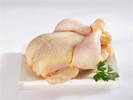 A whole chicken on a platter Stock Photo - Premium Royalty-Free, Code: 659-01856262