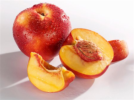 A whole nectarine and one cut into pieces Stock Photo - Premium Royalty-Free, Code: 659-01856459
