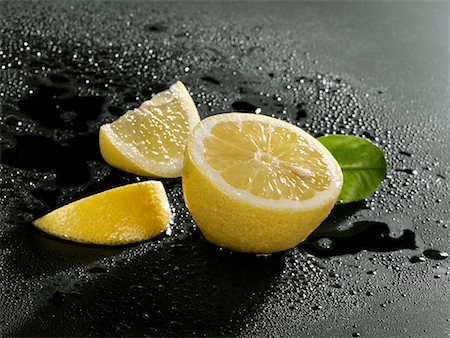Half a lemon and two lemon wedges Stock Photo - Premium Royalty-Free, Code: 659-01856463