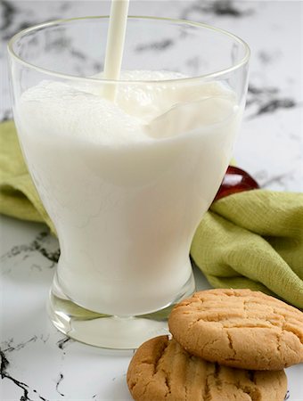 peanut cookie - A glass of milk with two peanut butter biscuits Stock Photo - Premium Royalty-Free, Code: 659-01856478