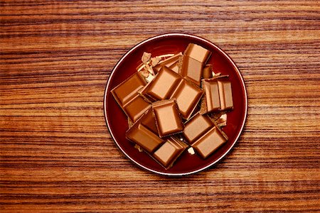 Pieces of chocolate on brown plate Stock Photo - Premium Royalty-Free, Code: 659-01856586