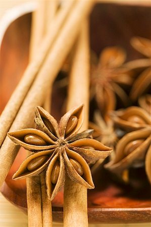 spices bowl closeup - Star anise and cinnamon sticks in wooden bowl Stock Photo - Premium Royalty-Free, Code: 659-01856792