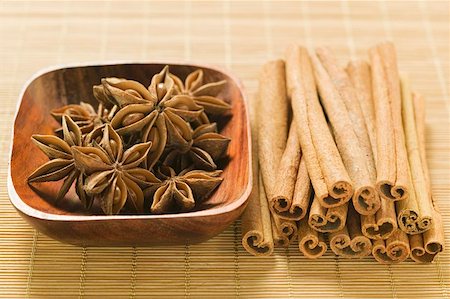 simsearch:659-08897024,k - Star anise in wooden bowl, cinnamon sticks beside it Stock Photo - Premium Royalty-Free, Code: 659-01856793