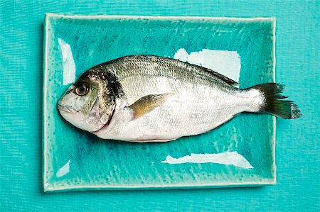fresh blue fish - Fresh sea bream on blue plate Stock Photo - Premium Royalty-Free, Code: 659-01856960
