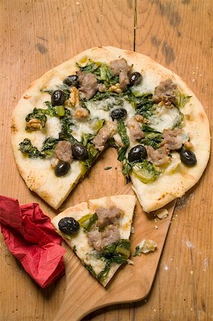 Pizza with tuna, chard and olives a slice cut Stock Photo - Premium Royalty-Free, Code: 659-01857314