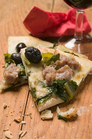 Two slices of pizza with tuna, chard and olives Stock Photo - Premium Royalty-Free, Code: 659-01857315