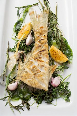 simsearch:659-06185095,k - Fried sea bass with herbs, garlic and lemon Stock Photo - Premium Royalty-Free, Code: 659-01857382