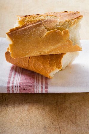 simsearch:659-01843027,k - Two pieces of baguette on tea towel Stock Photo - Premium Royalty-Free, Code: 659-01857437