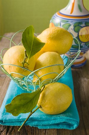 simsearch:659-01857464,k - Fresh lemons with leaves in wire basket Stock Photo - Premium Royalty-Free, Code: 659-01857457