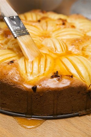 preparation of apple pie - Brushing apple cake with egg yolk Stock Photo - Premium Royalty-Free, Code: 659-01857593