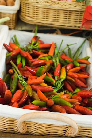 Fresh chili peppers in a basket at a market Stock Photo - Premium Royalty-Free, Code: 659-01857644