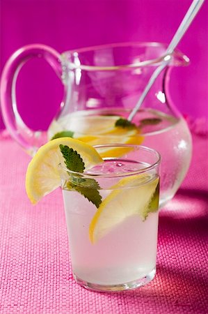 Lemonade with ice cubes and lemon balm Stock Photo - Premium Royalty-Free, Code: 659-01857729