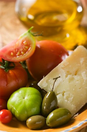 simsearch:659-01854208,k - Tomatoes, green olives and Parmesan on plate, olive oil Stock Photo - Premium Royalty-Free, Code: 659-01857833