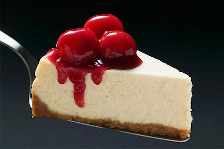 Slice of cheesecake with cherries on cake server Stock Photo - Premium Royalty-Free, Code: 659-01857938