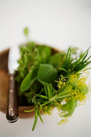 Assorted herbs in wooden bowl with knife Stock Photo - Premium Royalty-Free, Code: 659-01858078