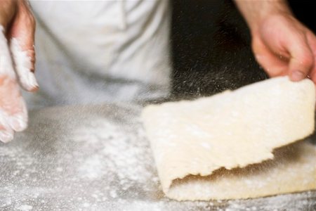 dredged - Sprinkling pasta dough with flour Stock Photo - Premium Royalty-Free, Code: 659-01858214