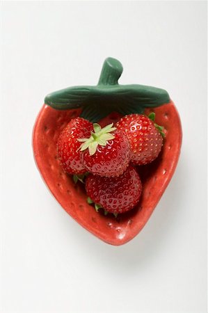 simsearch:659-03526764,k - Four strawberries in red strawberry-shaped dish Fotografie stock - Premium Royalty-Free, Codice: 659-01858424