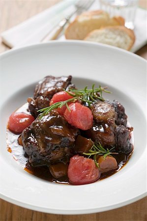 Braised oxtail with tomatoes and rosemary Stock Photo - Premium Royalty-Free, Code: 659-01858514