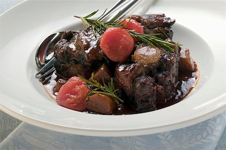 Braised oxtail with tomatoes and rosemary Stock Photo - Premium Royalty-Free, Code: 659-01858516