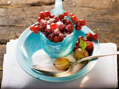 Redcurrants in glass jug, sugar, gooseberries, raspberry Stock Photo - Premium Royalty-Free, Code: 659-01858599