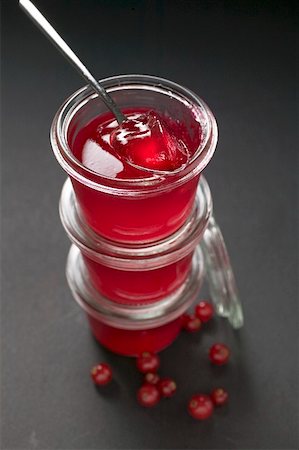 Three jars of redcurrant jelly, one opened, with spoon Stock Photo - Premium Royalty-Free, Code: 659-01858716