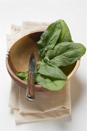 spinach leaf - Several spinach leaves in wooden bowl with knife Stock Photo - Premium Royalty-Free, Code: 659-01858886