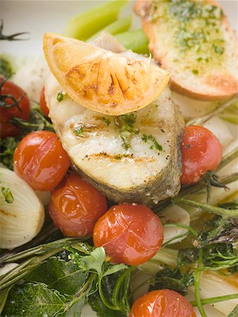 Sea bass cutlet with lemon on roasted vegetables Stock Photo - Premium Royalty-Free, Code: 659-01858947