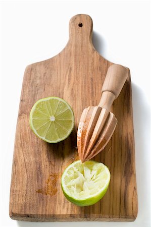 simsearch:659-03525022,k - Two lime halves, one squeezed, on chopping board Stock Photo - Premium Royalty-Free, Code: 659-01859176