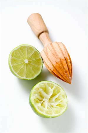 exprimidor de jugo - Two lime halves, one squeezed, with lemon squeezer Foto de stock - Sin royalties Premium, Código: 659-01859180