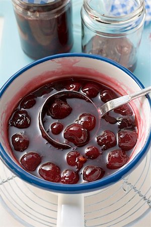 Ladling cherry jam into jars Stock Photo - Premium Royalty-Free, Code: 659-01859246