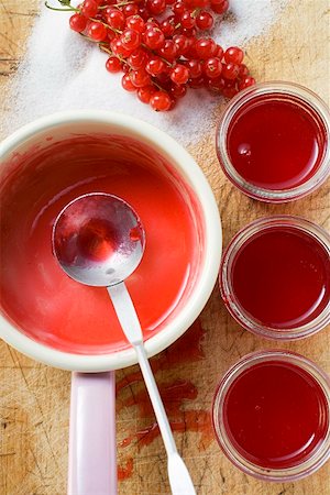 soft fruit conserve - Redcurrant jelly in a pan and in jam jars Stock Photo - Premium Royalty-Free, Code: 659-01859252