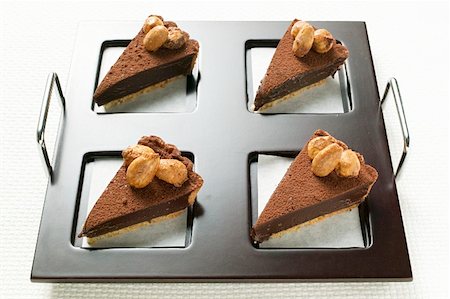 Four pieces of chocolate tart with almonds on tray Stock Photo - Premium Royalty-Free, Code: 659-01859311